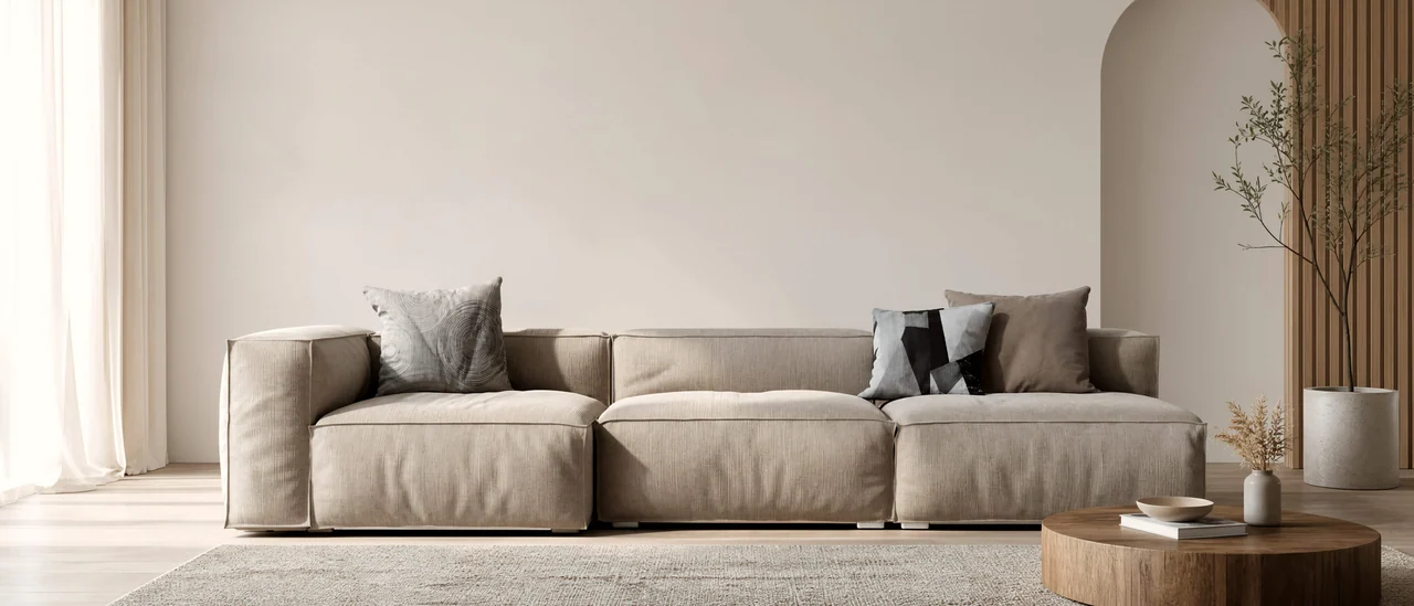A modular pale sofa presented in a softly lit interior