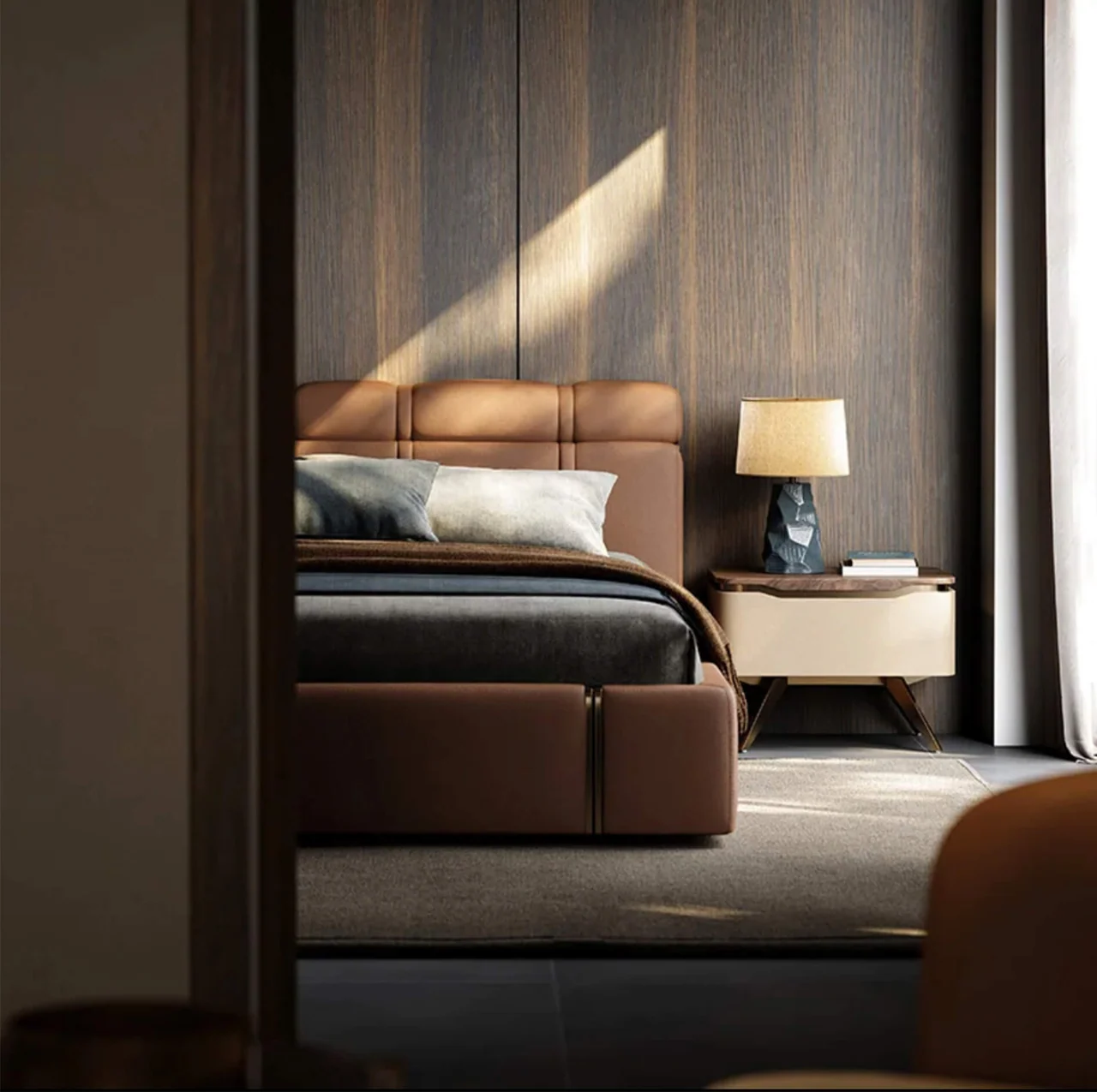 A warm bedroom viewed through a dark architectural opening