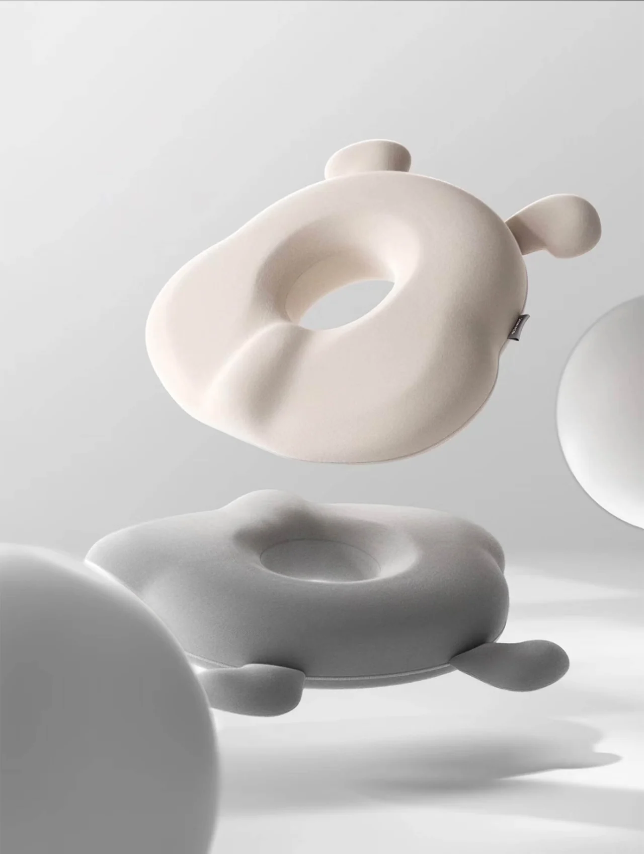 Abstract pale sculptural forms suspended over a reflective surface